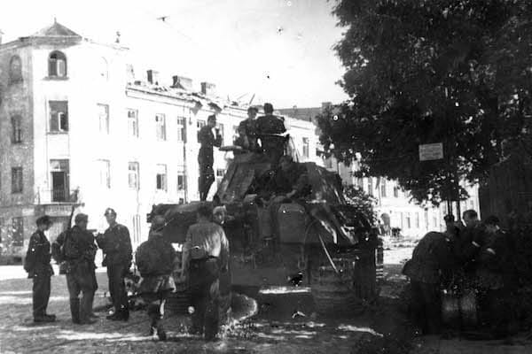 Polish soldiers pose atop their captured tank.
