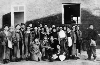 Women prisoners of Gęsiówka pose with their liberators.